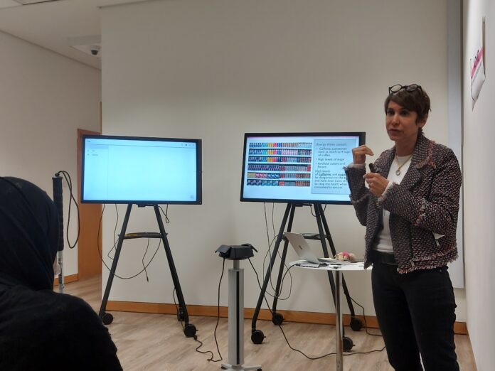 Fariba Shaikh, a senior instructor in the College of Natural and Health Sciences, explains the negative effects of caffeine at a welcome-back gathering for Students of Determination in Dubai on Jan. 24. (Yulia Medvedeva)