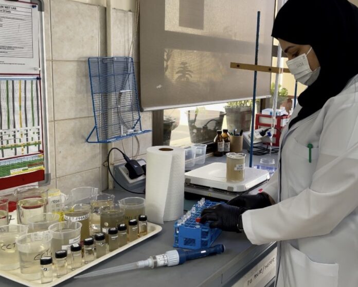 Maitha Alajmani performs a test in her lab.