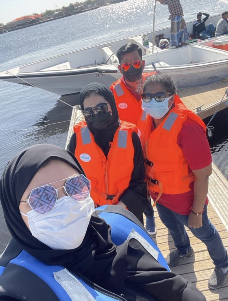 Maitha Alajmani poses for a selfi with her three colleagues outdoors. 